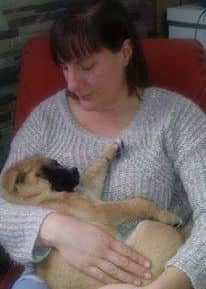 Jasmine cradles a rescue dog.