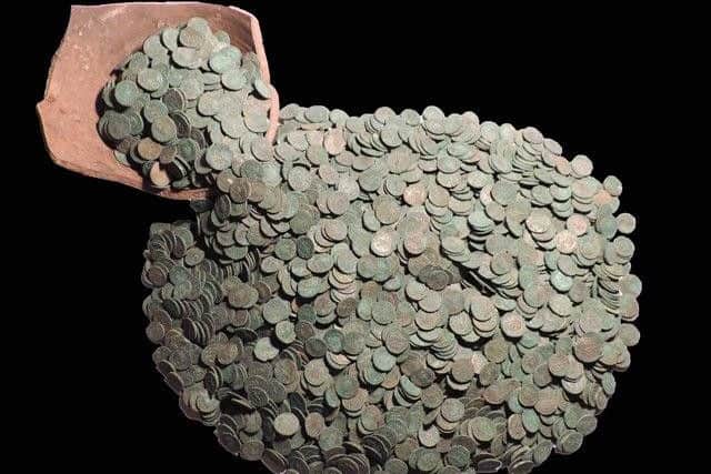 The Roman coin hoard and fragment of pot that it was buried in, near Rauceby.