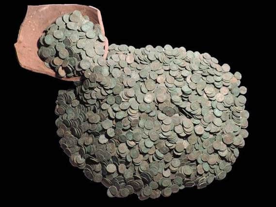 The Roman coin hoard and fragment of pot that it was buried in, near Rauceby.