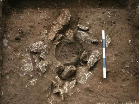 Archaeologists found the coin hoard had been buried in a stone lined hole in what is suggested to have been a ritual burial.