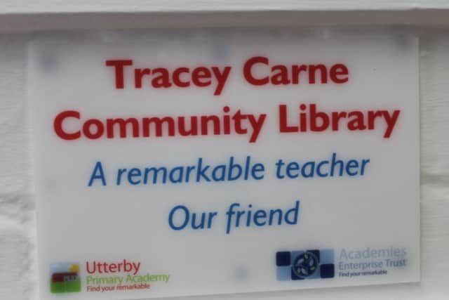 The plaque, above the community library, in memory of Mrs Carne.