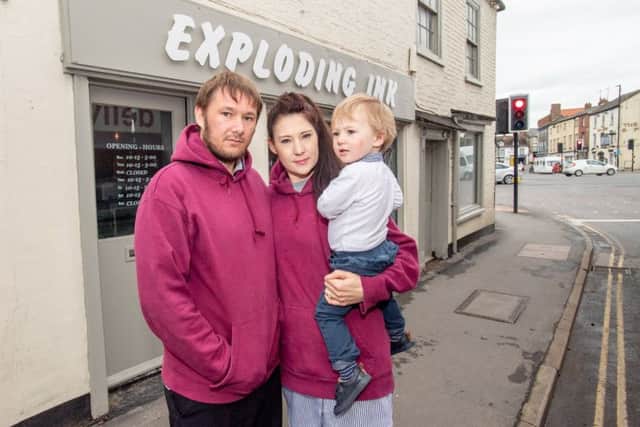Karl and Kerry Watling with their son Mason, 1, outside Exploding Ink. EMN-191005-121558001