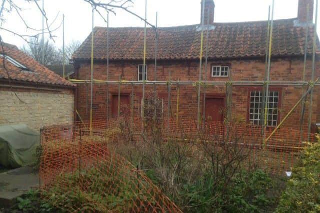 Scaffolding around Mrs Smith's Cottage at Navenby. EMN-190514-154414001