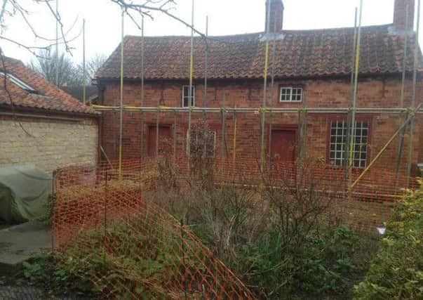 Scaffolding around Mrs Smith's Cottage at Navenby. EMN-190514-154414001