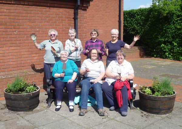 Ruskington WI president Christine Casey and fellow members who helped to plant the commemorative flower barrell on their groups centenary. EMN-190521-104833001