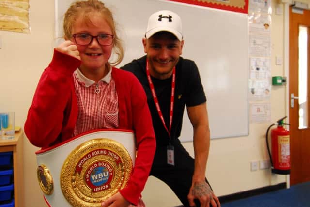 Lincoln boxer Nathan Decastro allowed Nocton School pupils to try on his WBU winners belt during his visit. EMN-190521-125636001