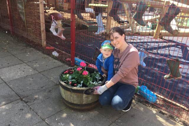 Volunteers help give Boston West Academy's garden a spring clean