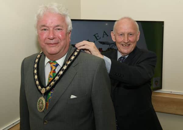 Sleaford Town Council elect new mayor Coun Adrian Snookes, receiving his chain of office from outgoing mayor Grenville Jackson. EMN-190516-132934001