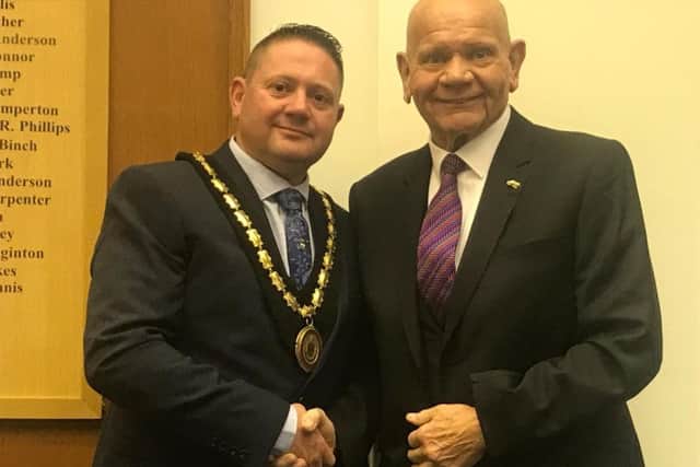Coun Sid Dennis (right) hands over the chain of office to the new Mayor of Skegness Coun Mark Dannatt.