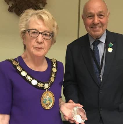 New NKDC chairman, Coun Susan Waring, presents the past chairman's medal and gift to retiring chairman Geoff Hazelwood. EMN-190517-170122001