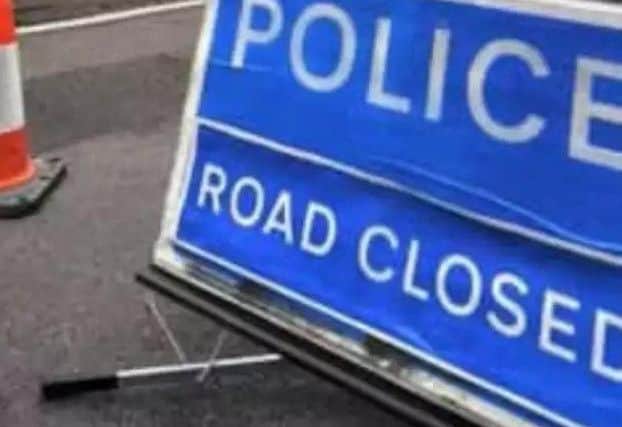 Police road closed sign