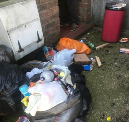 The rubbish is spilling across the path to the entrance and is visible from the public pavement. ANL-190520-145604001