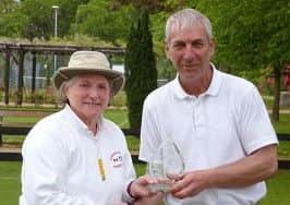 Singles winner Mike Bilton receives his trophy from Pauline Donner, chairperson of Woodhall Spa Croquet Club.