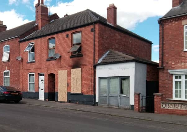 Boarded up. Tim Sampson's fire damaged home in Queen Street, Sleaford. EMN-190524-175313001
