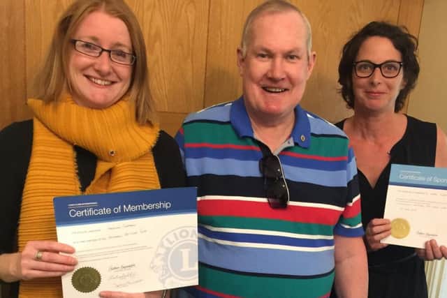 New lion Caroline Chapman joins Woodhall Spa Lions group, with her sponsor Katie Liddy and president John Ginty. EMN-190530-094353001