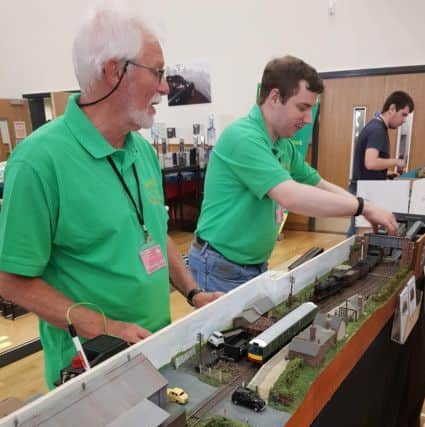 Sleaford Model Rail Club members demonstrating one of their layouts at the show at St George's Academy. EMN-190306-235602001