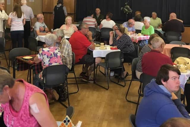 Villagers tucking in at Heckington Village Hall - 140 breakfasts were served at the event. Photo: Jacki Wright EMN-190406-000436001