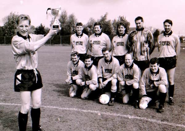The Helpringham football team with their cup in 1994. EMN-190606-152711001