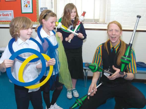 Bradley Gagg, seven, Katie Warren, nine, and Iona Roberts, eights, learn how to juggle.