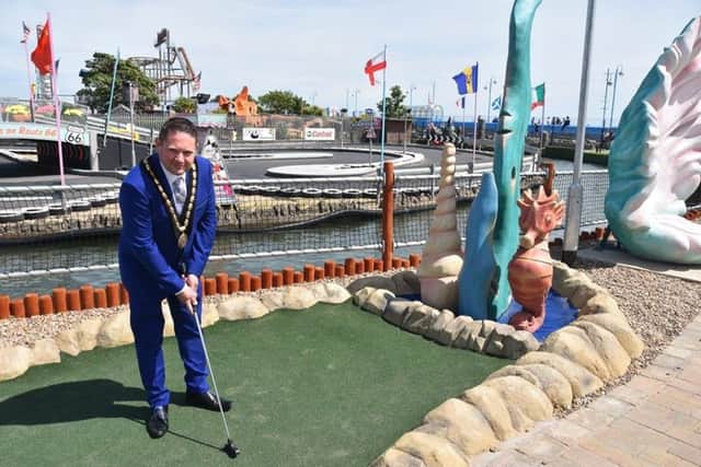 Skegness Mayor Coun Mark Dannatt enjoys on of Skegness' newest attractions - Atlantis crazy golf. Photo: Barry Robinson. ANL-191006-131542001