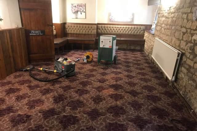 Le-Anne and Craig Askew spent Tuesday cleaning and drying the carpets only to see them under water again later. EMN-190613-115304001