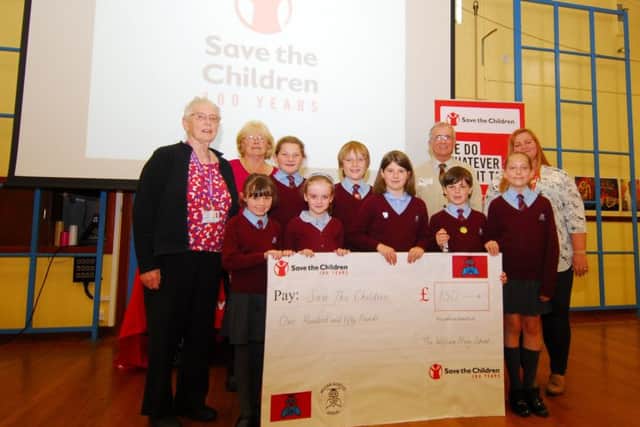Bishop's Visitor Beryl Risdell with William Alvey School pupils presenting ?150 raised by their Smartie tube challenge to Frederick Dole and Kelly Maton of Save The children. EMN-190618-101305001