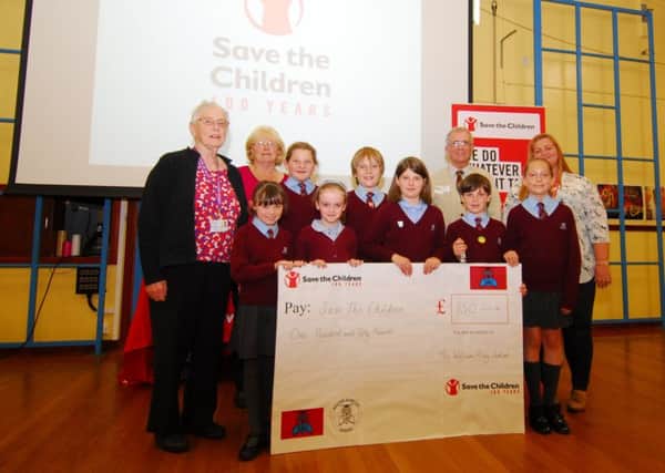 Bishop's Visitor Beryl Risdell with William Alvey School pupils presenting ?150 raised by their Smartie tube challenge to Frederick Dole and Kelly Maton of Save The children. EMN-190618-101305001