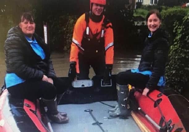 Lincolnshire Fire and Rescue helped Tracey Fiddler and Lisa Chapman of Bluebird Care reach their customer at Great Steeping in a dinghy.