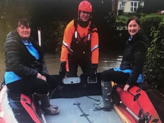Lincolnshire Fire and Rescue helped Tracey Fiddler and Lisa Chapman of Bluebird Care reach their customer at Great Steeping in a dinghy.