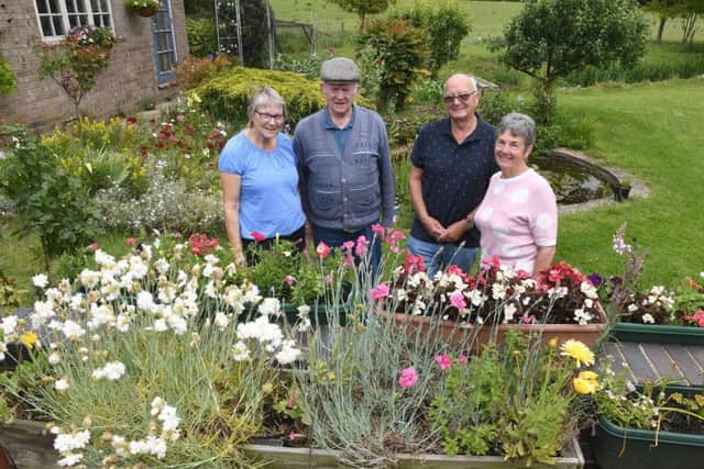 Wilsford Open Gardens. L-R Betty Groves and Reg Groves in their garden with Tony Maslin and Joan Maslin. EMN-190617-105355001