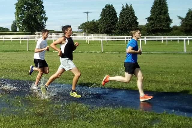 Tackling the temporary water obstacle at Saturday's parkrun EMN-190617-160405002