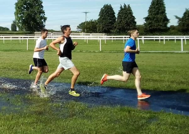 Tackling the temporary water obstacle at Saturday's parkrun EMN-190617-160405002