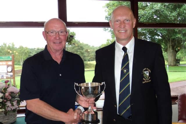 Overall winner Colin Law with men's captain Bob Pearce (right) EMN-190617-145326002