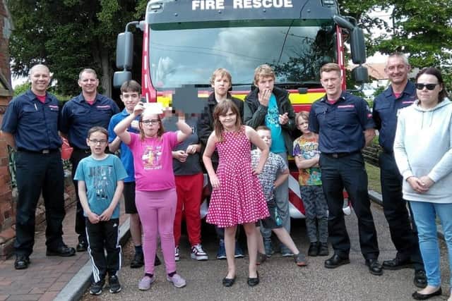 The Rainbow Flyers group with the crew of Sleaford Fire Station. Image supplied.