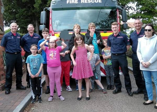 The Rainbow Flyers group with the crew of Sleaford Fire Station. Image supplied.