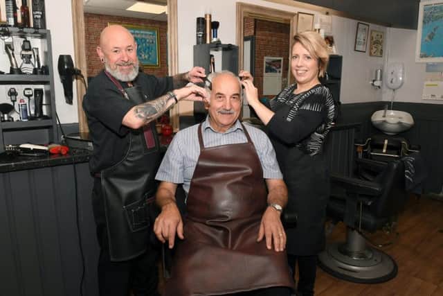 Giovanni Galati, seated, with fellow hairdressers Patrick Harland and Dana Rowe