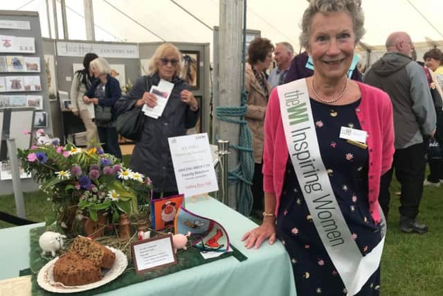 Janis Tunnerly, Lincolnshire South Federation Trustee, show secretary for the WI tent and a member of Wellingore WI praising the Down on the Farm entries.