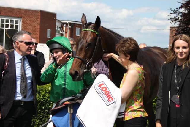 Jamie Moore tells Louth trainer Steve Gollings (left), how he rode Rococo Style (7/2) to victory, with part-owner and racecourse general manager Nadia Powell (right). Picture: Peter Thompson EMN-190624-092851002