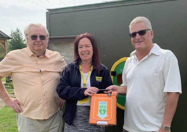 Pictured from left are Noel Bush, Kirsty Raywood and Pete Smith with the defibrillator. EMN-190624-131244001