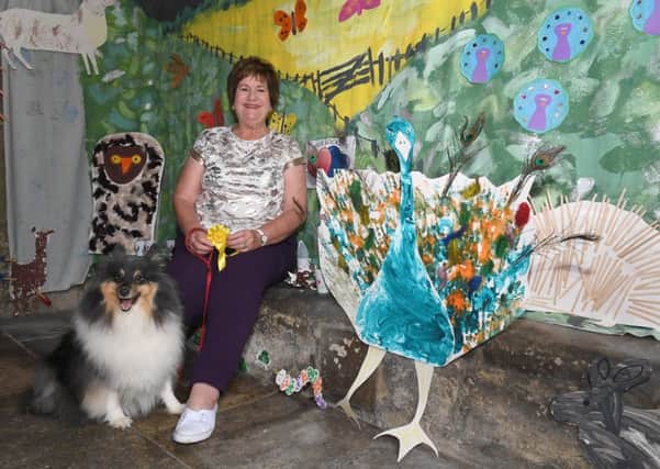 Great Hale Wildlife Festival. Church Warden Elaine Huckle with her dog Cody, with display by Little Lockets Nursery. EMN-190625-002953001