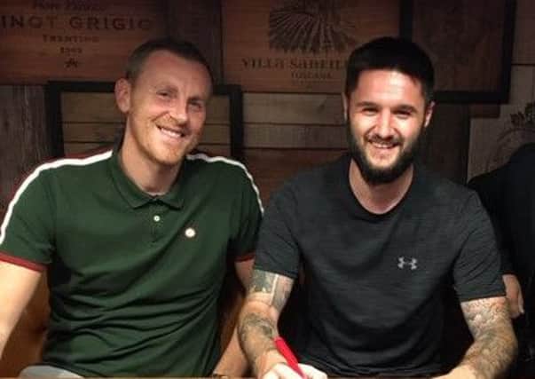 Dominic Knowles signs on, with Craig Elliott.