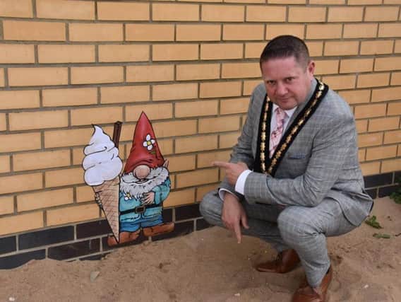 Skegness Mayor Coun Mark Dannatt checks out one of the gnomes that have sprung up around town. Photo: Barry Robinson.