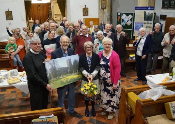 Alan and Lynda Saxton receive their gifts and good wishes from Canon Robinson, Val Waddington and parishioners EMN-190107-083017001