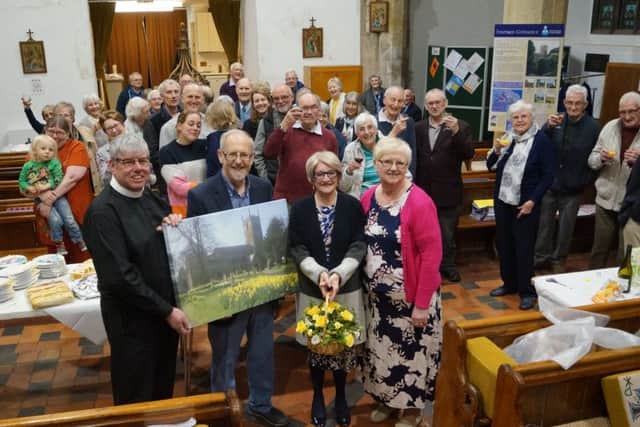 Alan and Lynda Saxton receive their gifts and good wishes from Canon Robinson, Val Waddington and parishioners EMN-190107-083017001