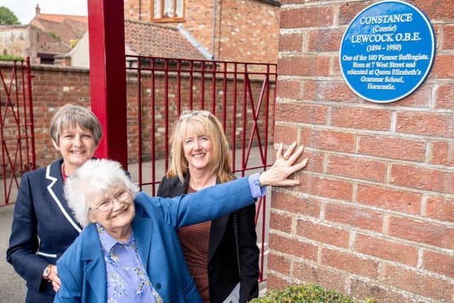 Relatives of Connie are pictured standing next to the blue plaque with Heather Payne, Headteacher at QEGS. EMN-190107-144513001