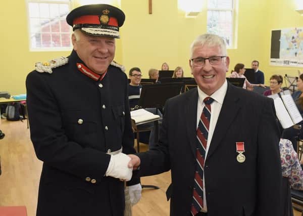 Former Director of Music of Sleaford Concert Band, Jim McQuade receiving BEM from Lord Lieutenant Toby Dennis in October of last year.