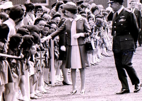 HM the Queen on her Royal visit to RAF College Cranwell in 1970 meets local Brownies on her walk about. EMN-190907-152529001