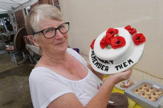 Craft fair and garden party in aid of British Legion poppy appeal. Wendy Chatten with cake raffle. EMN-190807-114249001
