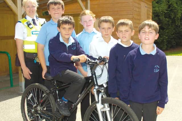 Police Community Support Officer Jayne Richardson with, from left, Thomas Grooby, 11, Daisy Davison, 10, Jordan Seal, 10, Luke Edwards 10, Joe Irving, 10, and Callum Grooby, nine, on his bike.