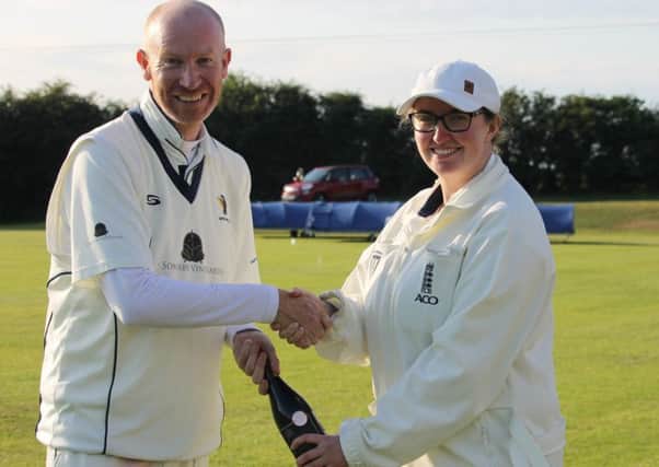 Caistor's Sean Woolley receives the man-of-the-match award from umpire Beth Smith EMN-190715-154510002
